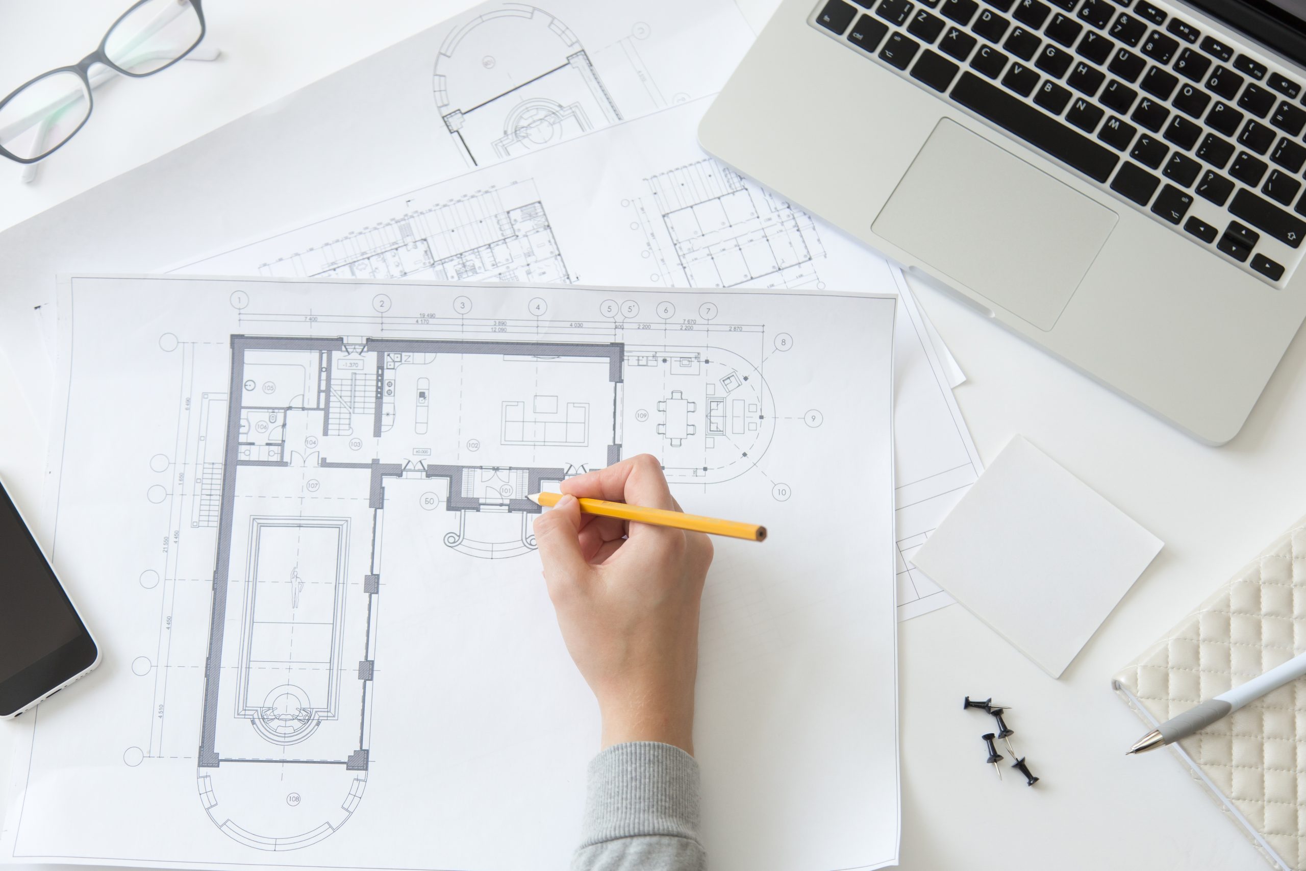 Top view of a hand making an architect drawing at the working desk, close up, education concept photo